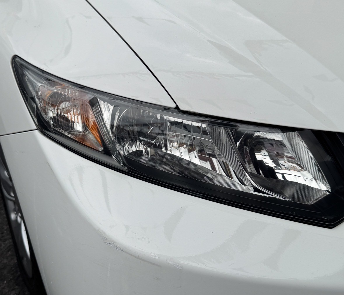Clear restored headlight after professional headlight restoration and UV protection